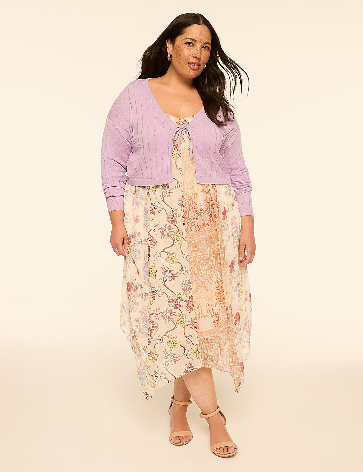 A woman in a floral dress and lavender cardigan stands against a plain, light background. Product Image 3
