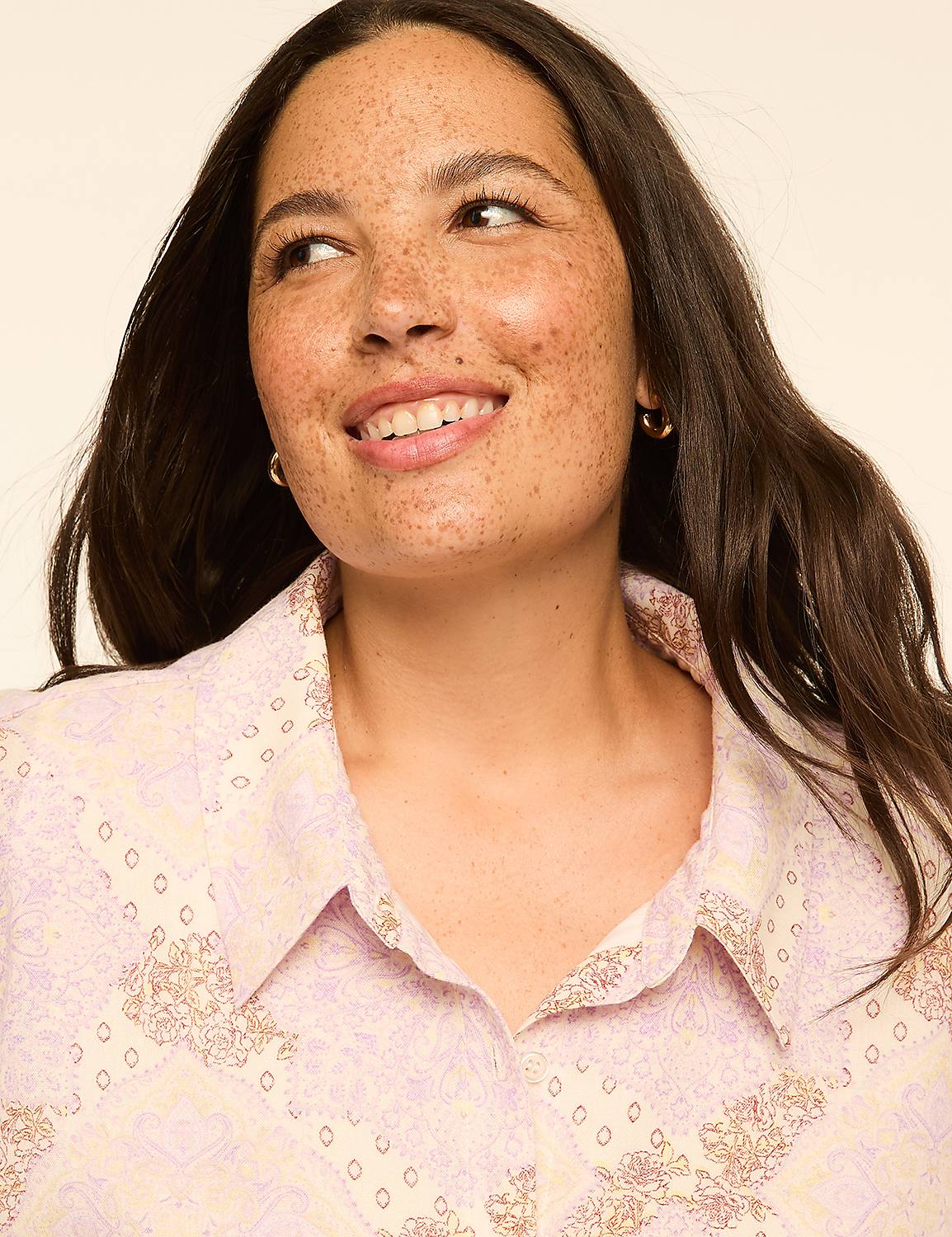 A woman with freckles smiles softly, looking to the side against a plain, light background. Product Image 3