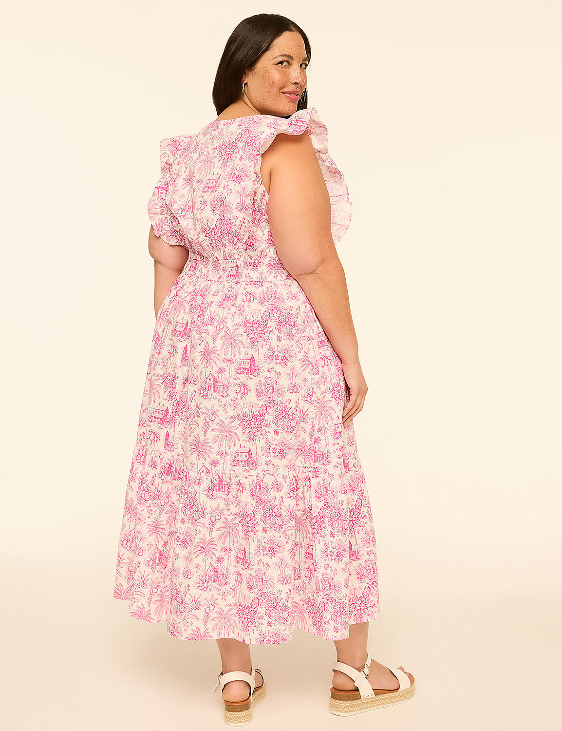 A woman in a pink floral dress stands against a plain, light-colored background. Product Image 2