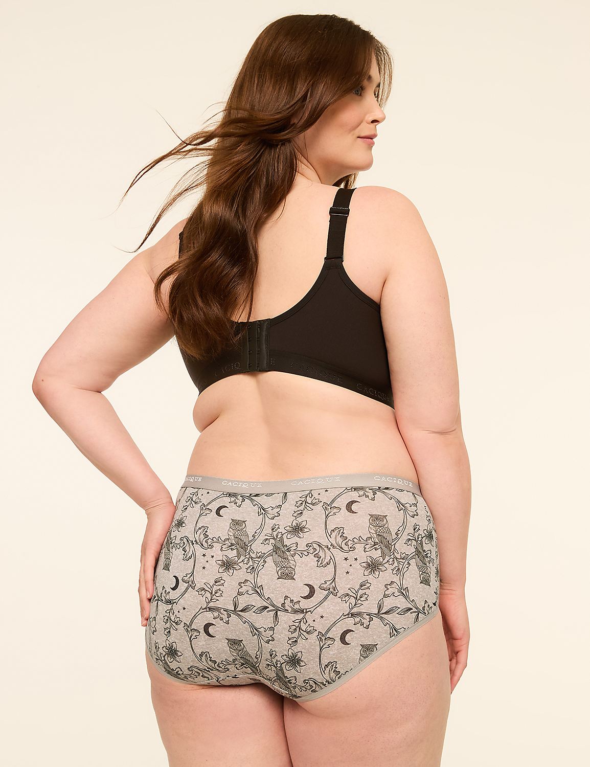 A woman with long brown hair wears a black bra and grey patterned underwear with owls and moons, against a plain cream background. Product Image 2