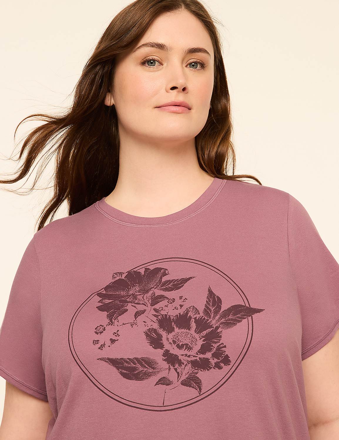 A woman in a mauve t-shirt with a floral design stands against a plain, light-colored background. Product Image 3