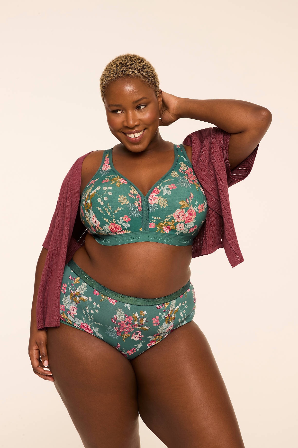 A smiling woman with short blonde hair poses in floral lingerie and a maroon cardigan against a plain, light-colored background. Product Image 7