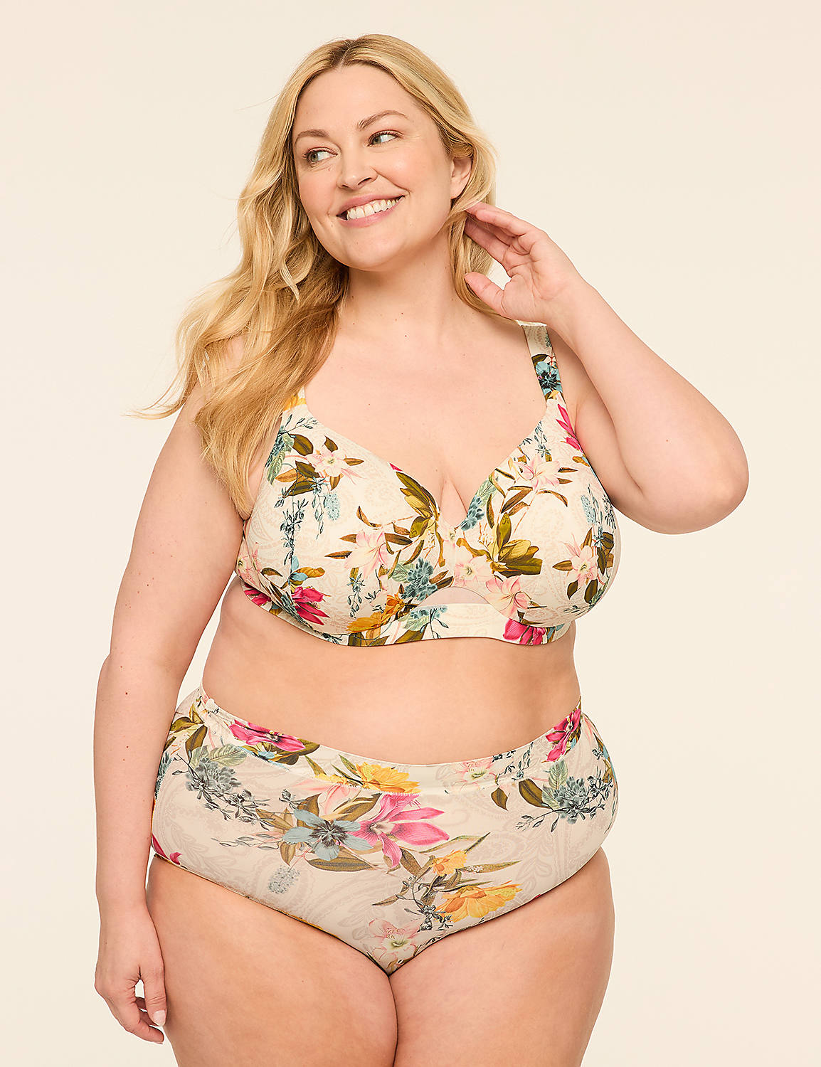 A smiling woman in floral lingerie stands against a plain, light-colored background. Product Image 4