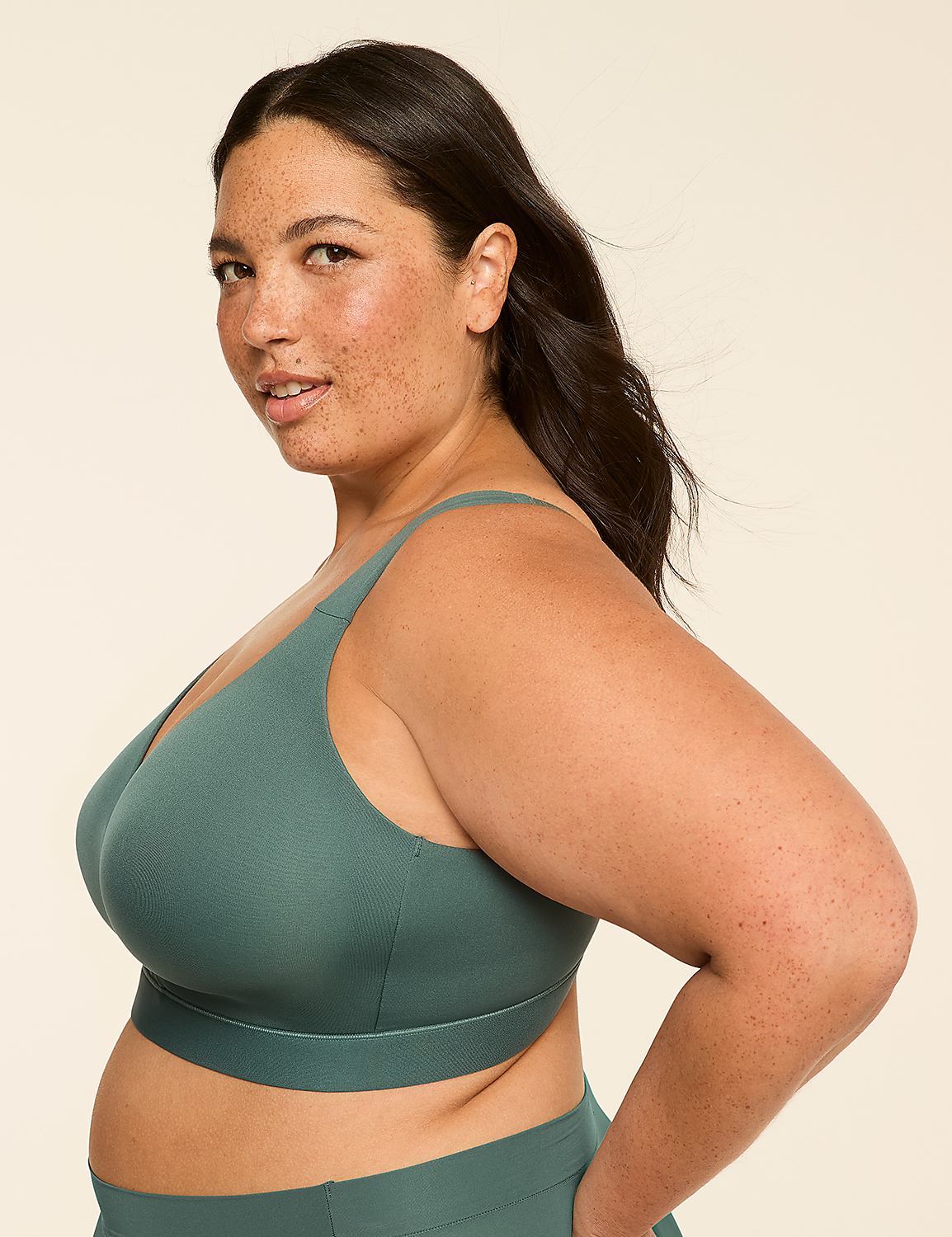 A woman with freckles in a teal bra and matching bottoms poses against a plain, light-colored background. Product Image 3