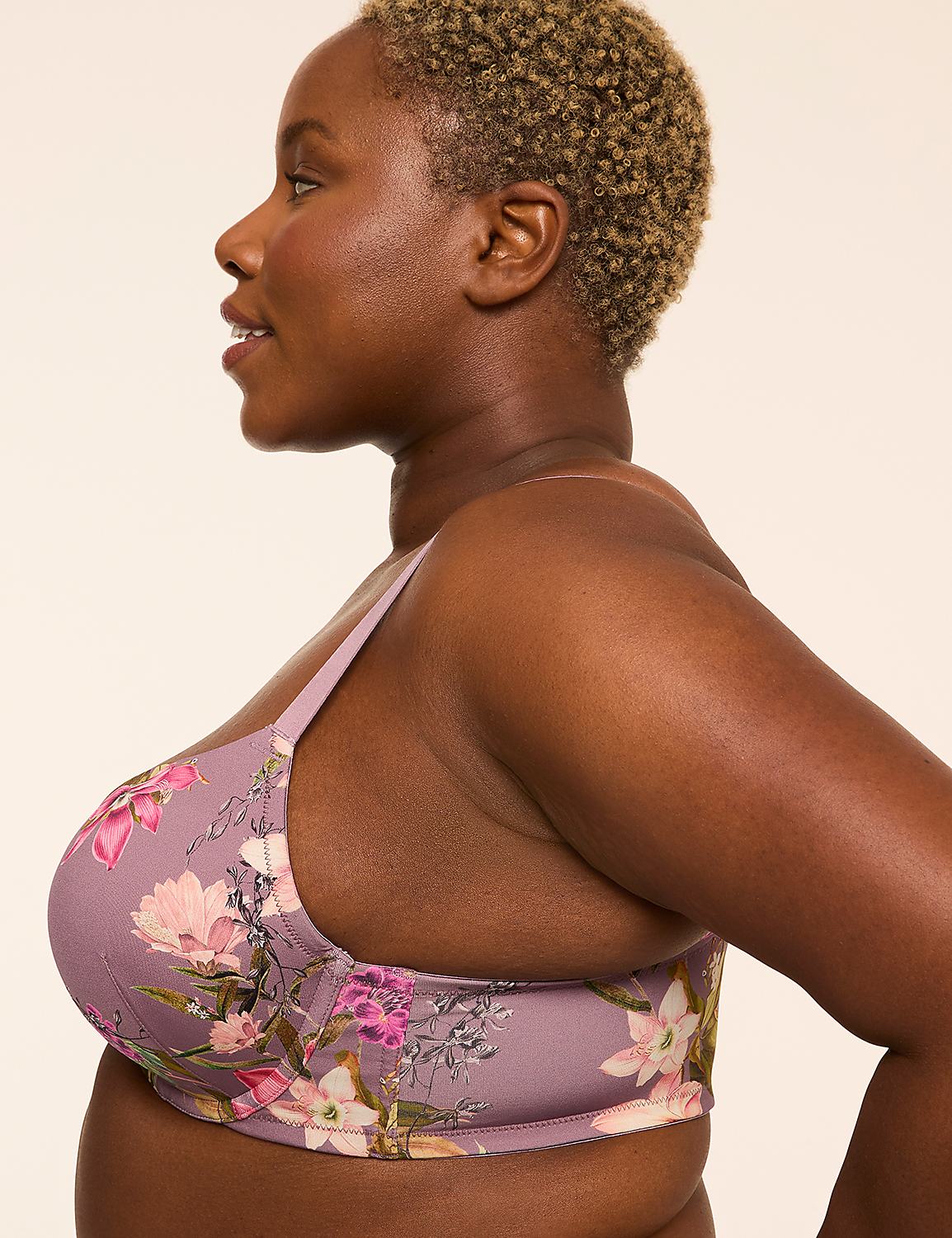 A woman with short, curly hair and a floral bra is shown in profile against a plain, light-colored background. Product Image 3