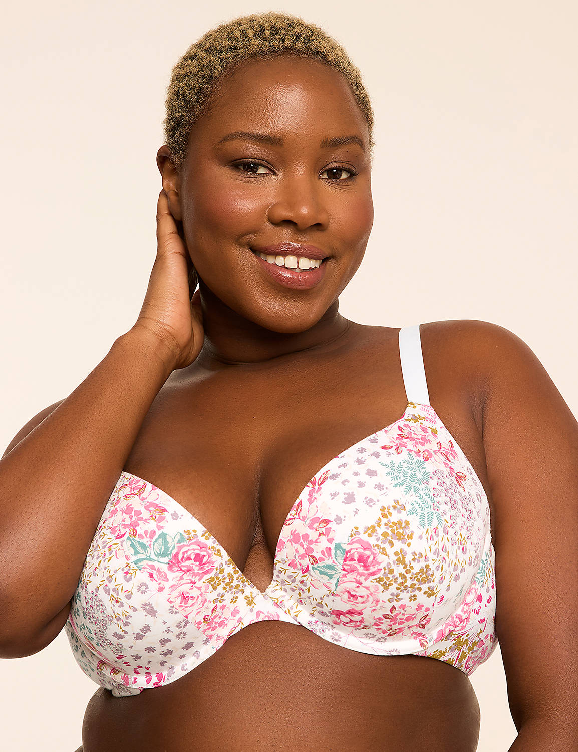 A smiling woman with short blonde hair wears a floral bra in the foreground against a plain, light background. Product Image 1