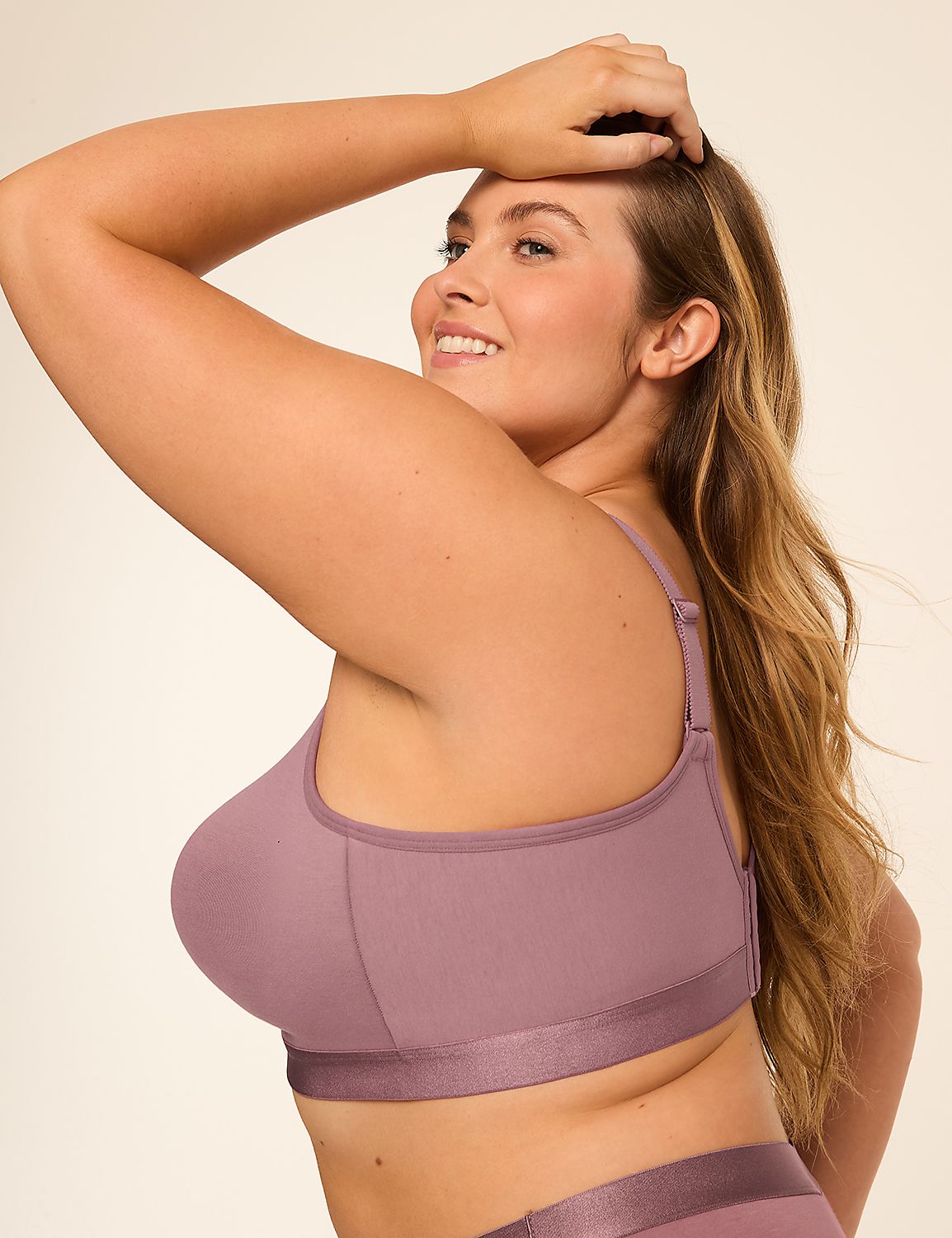 A woman in a mauve sports bra and matching underwear smiles over her shoulder against a plain, light background. Product Image 3