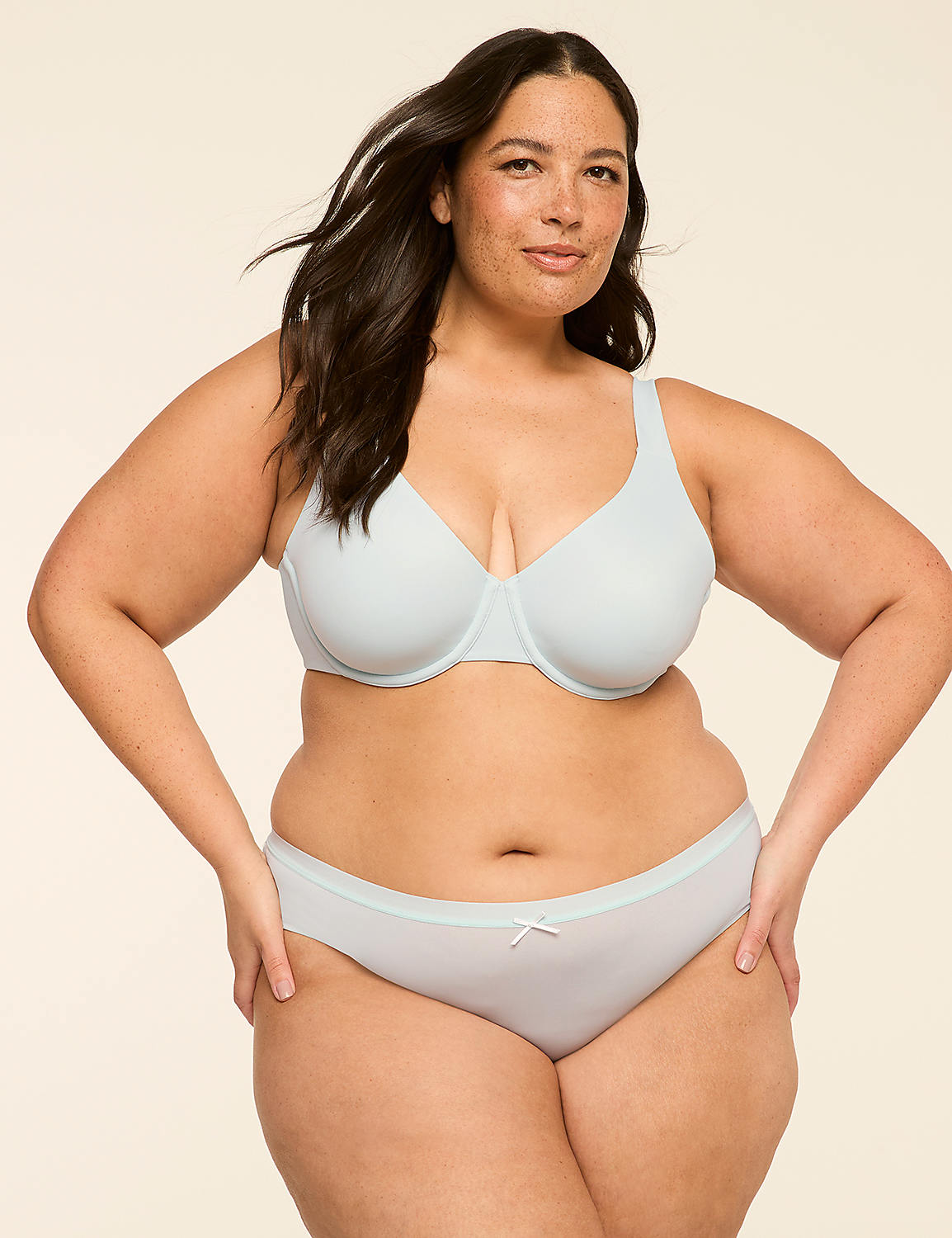 A woman with dark hair and freckles poses in light blue lingerie against a plain, light background. Product Image 3