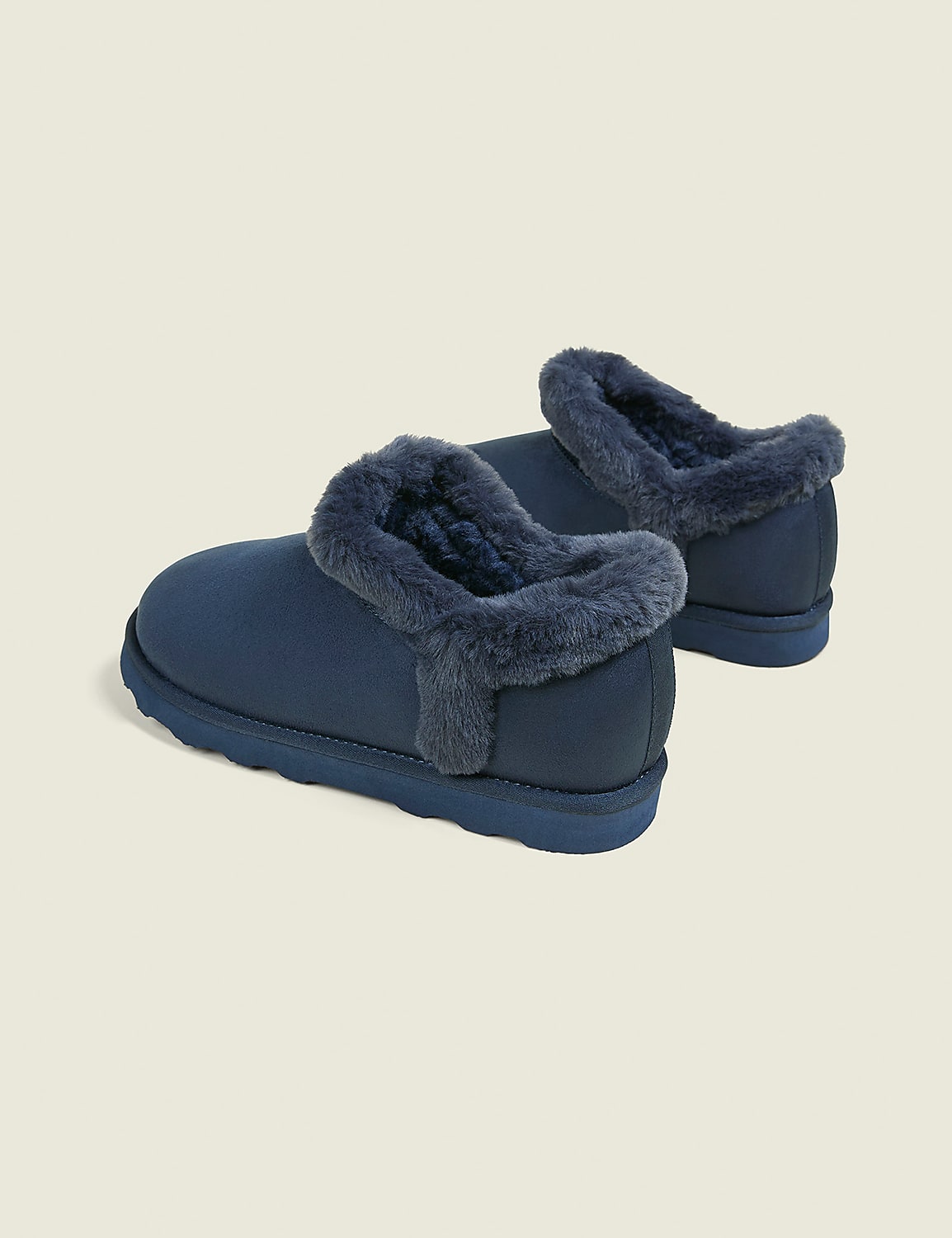 A pair of navy blue, fur-lined slippers rests on a plain, light gray background. Product Image 2