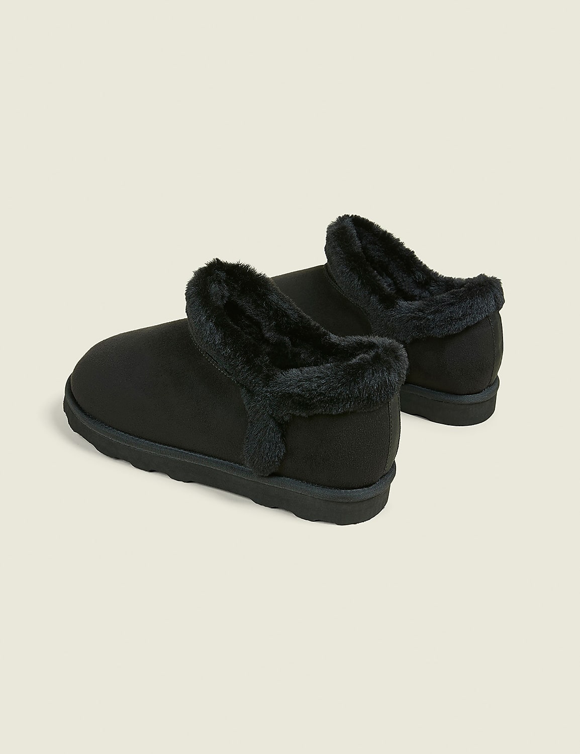 A pair of black, fuzzy-lined slippers rests on a plain, light gray background. Product Image 2