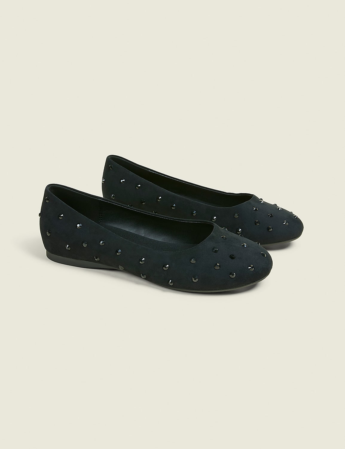 A pair of black studded ballet flats rests on a light beige background. Product Image 1