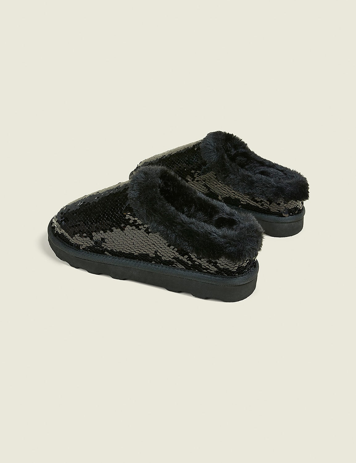 A pair of black sequined slippers with fluffy lining rests on a plain, light-colored background. Product Image 2