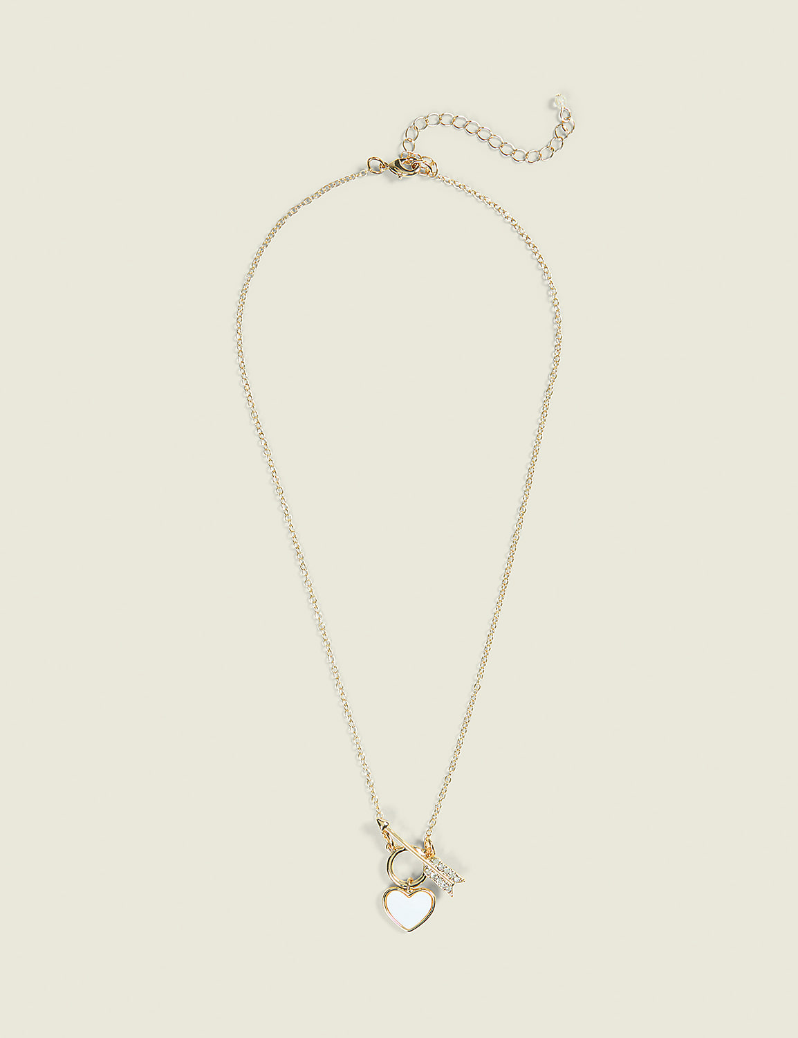 A delicate gold necklace with a heart-shaped pendant hangs against a plain, light-colored background. Product Image 1