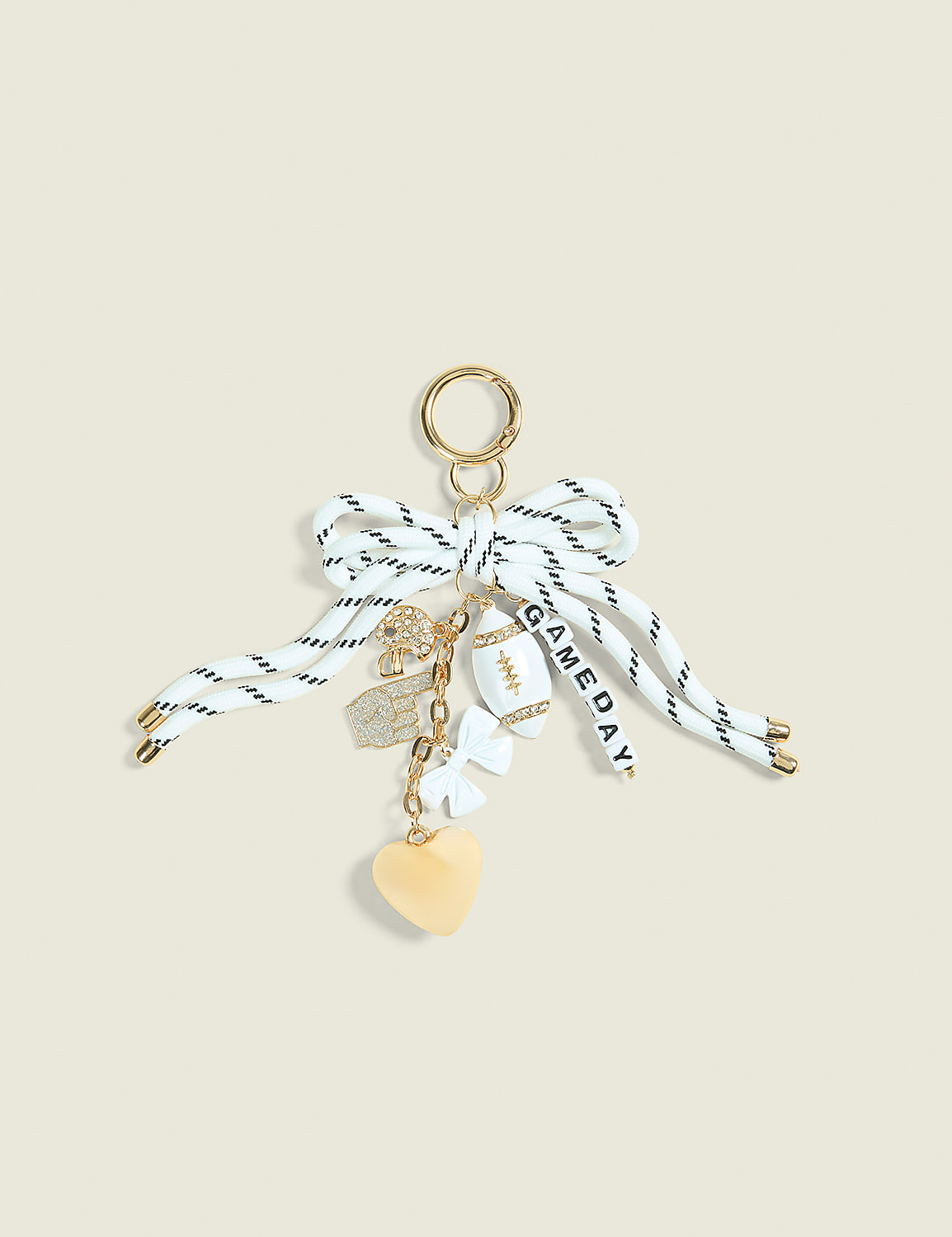 A white and black striped ribbon bow with various charms, including a football, heart, and dice, hangs against a plain, light-colored background. Product Image 1