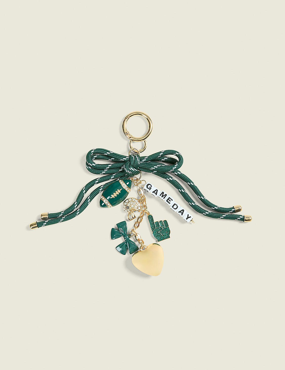 A green and white striped ribbon bow holds a collection of football-themed charms, including a football, a lucky clover, a foam finger, and a heart, against a plain cream background. Product Image 1