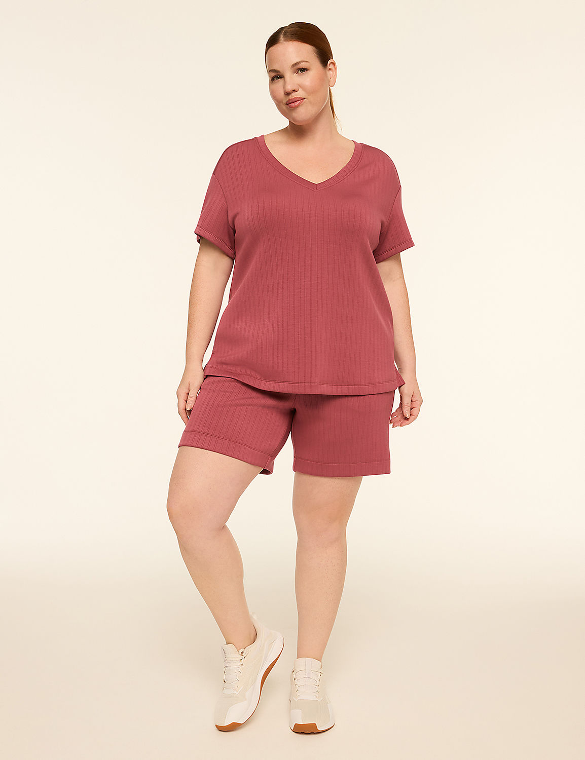 A woman in a rose-colored ribbed loungewear set stands against a plain, light-colored background. Product Image 3