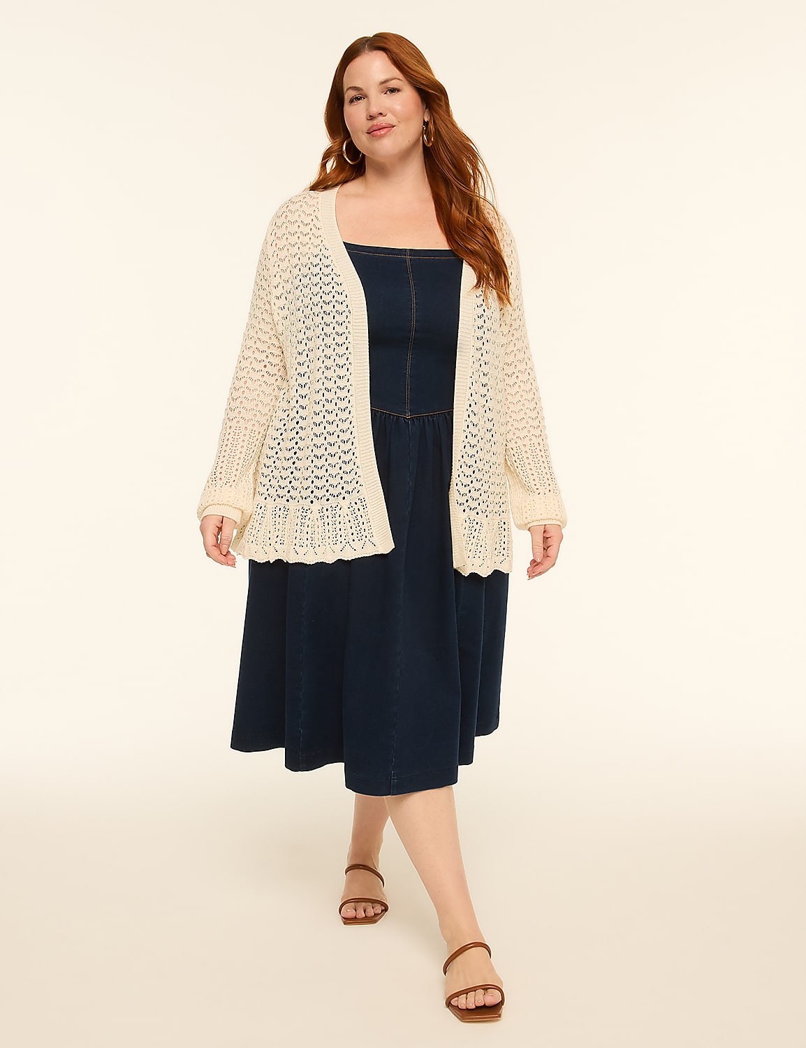 A woman in a denim dress and cream cardigan walks forward against a plain, light background. Product Image 3