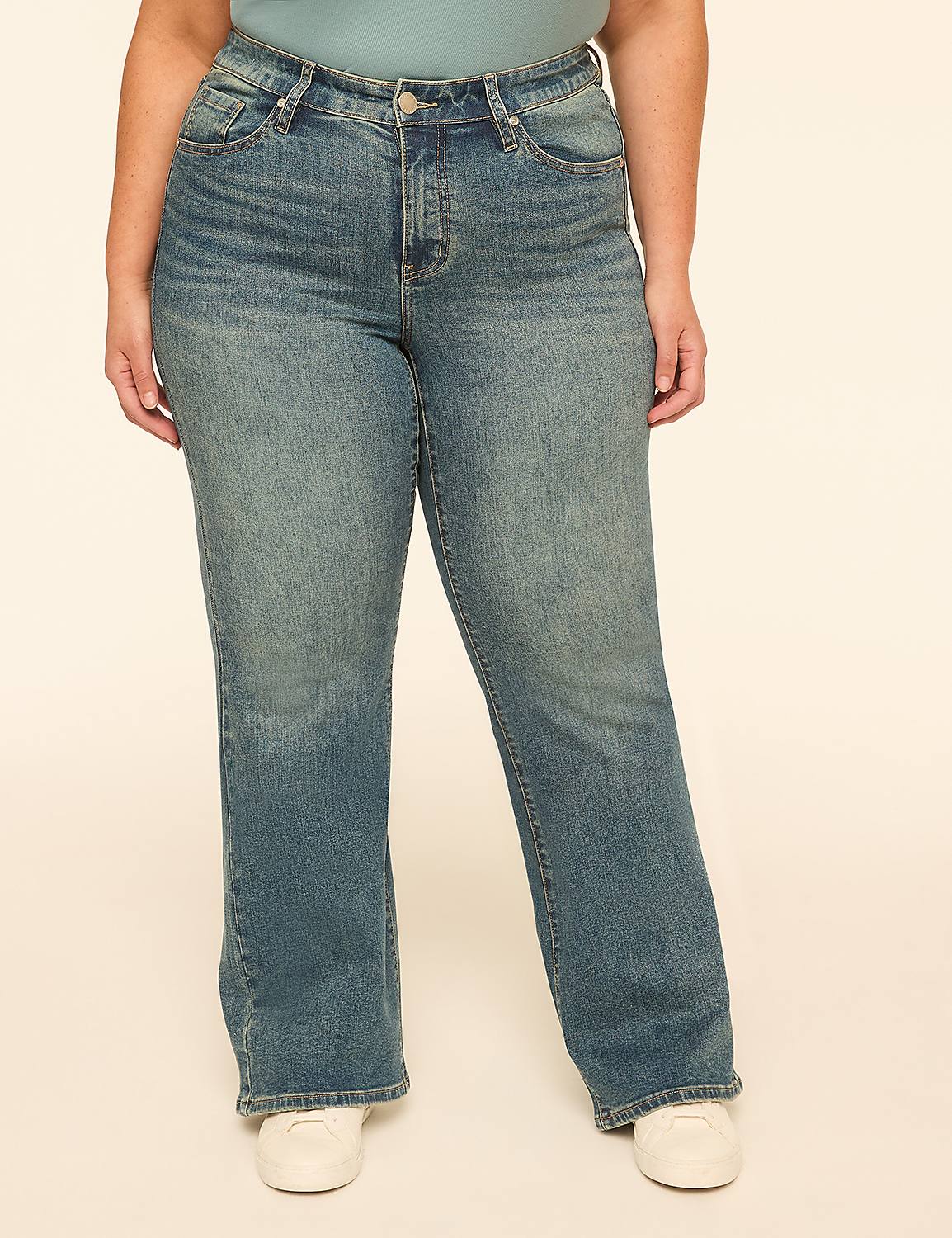 A person wearing blue jeans and white sneakers stands against a plain, light-colored background. Product Image 1
