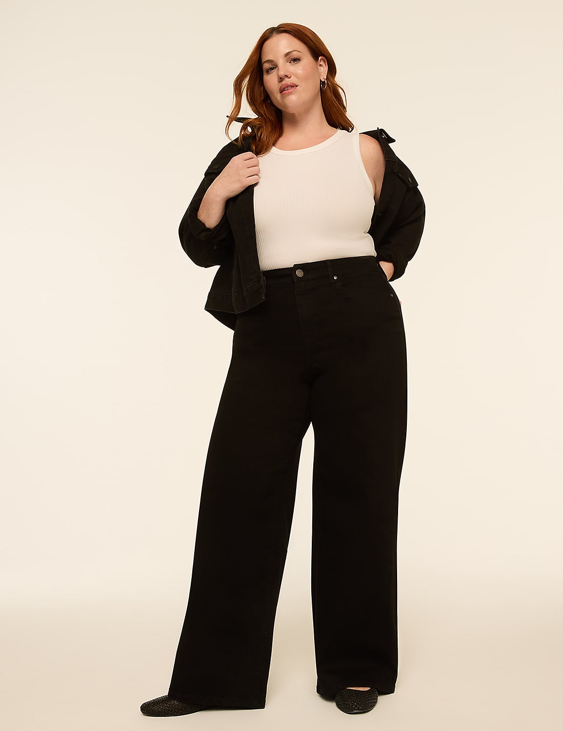 A woman in a white tank top, black jacket, and wide-leg black pants stands against a plain, light-colored background. Product Image 3