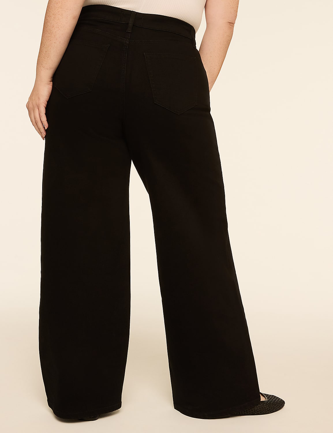 A person wearing black wide-leg pants stands against a plain, light-colored background. Product Image 2