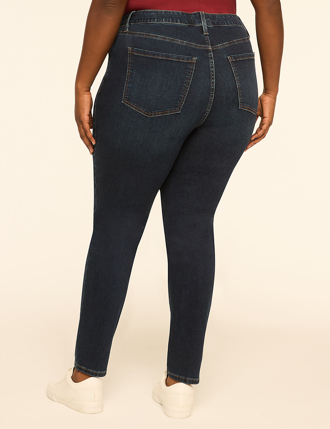 A person wearing dark wash skinny jeans and white sneakers stands against a plain, light-colored background. Product Image 2
