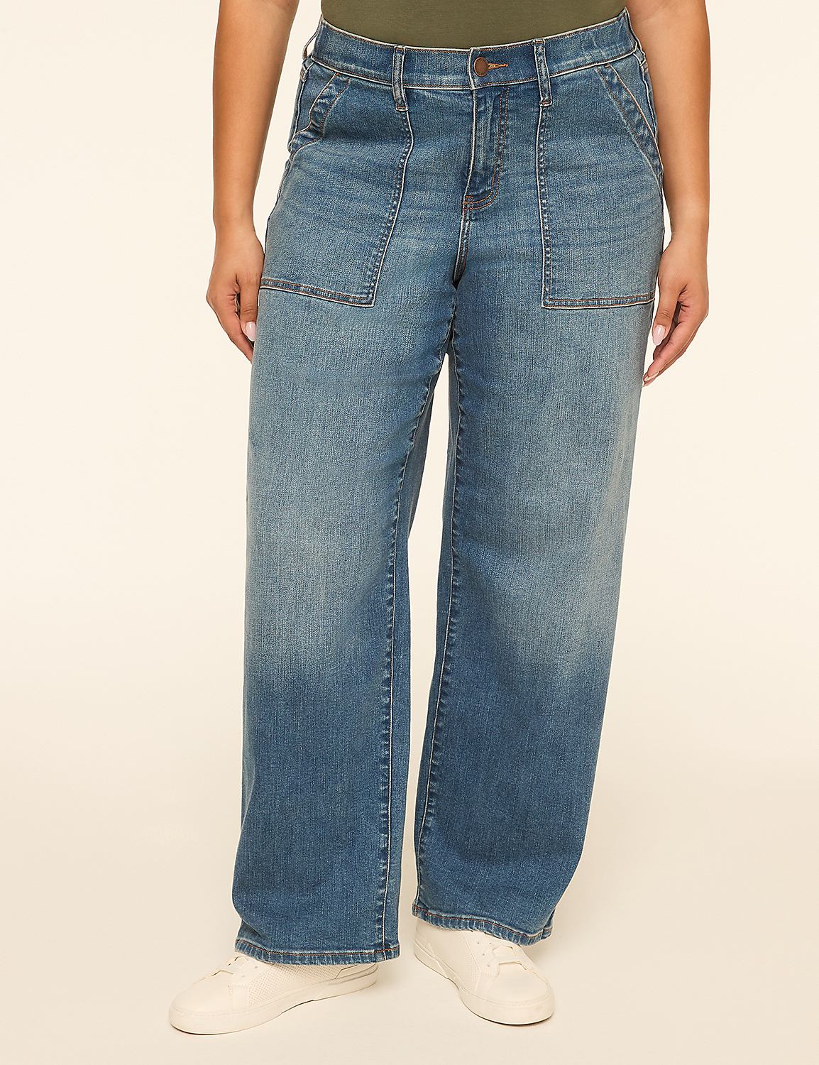 A person stands in wide-leg denim jeans with large front pockets, against a plain, light-colored background. Product Image 1
