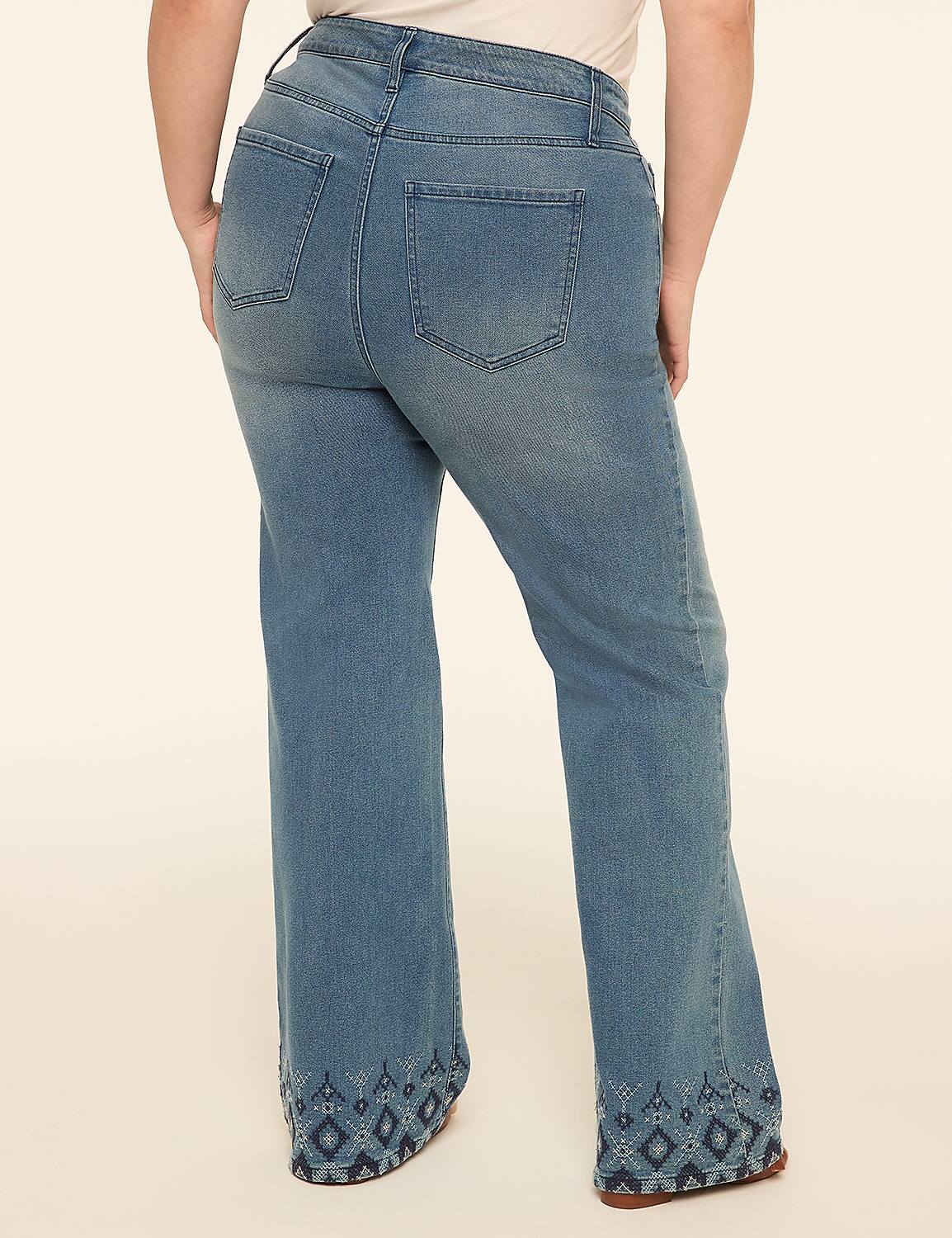 A person wearing flared jeans with embroidered hems stands against a plain, light-colored background. Product Image 2