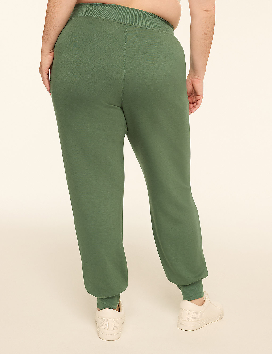 A person wearing green sweatpants and white sneakers stands against a plain, light-colored background. Product Image 2