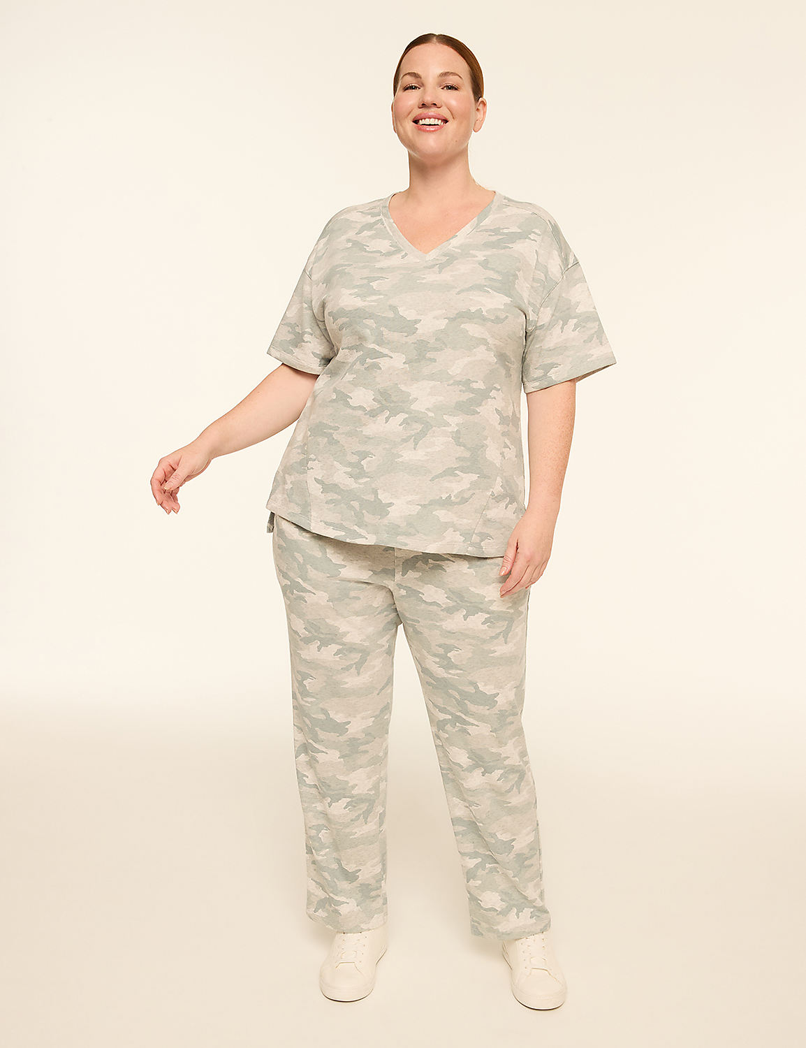 A woman in a camouflage pajama set stands against a plain, light background. Product Image 3