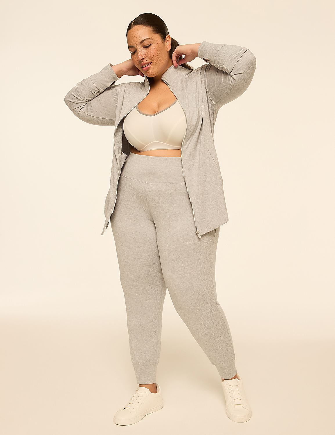 A woman in a grey loungewear set and white sneakers stands against a plain, light-colored background. Product Image 3