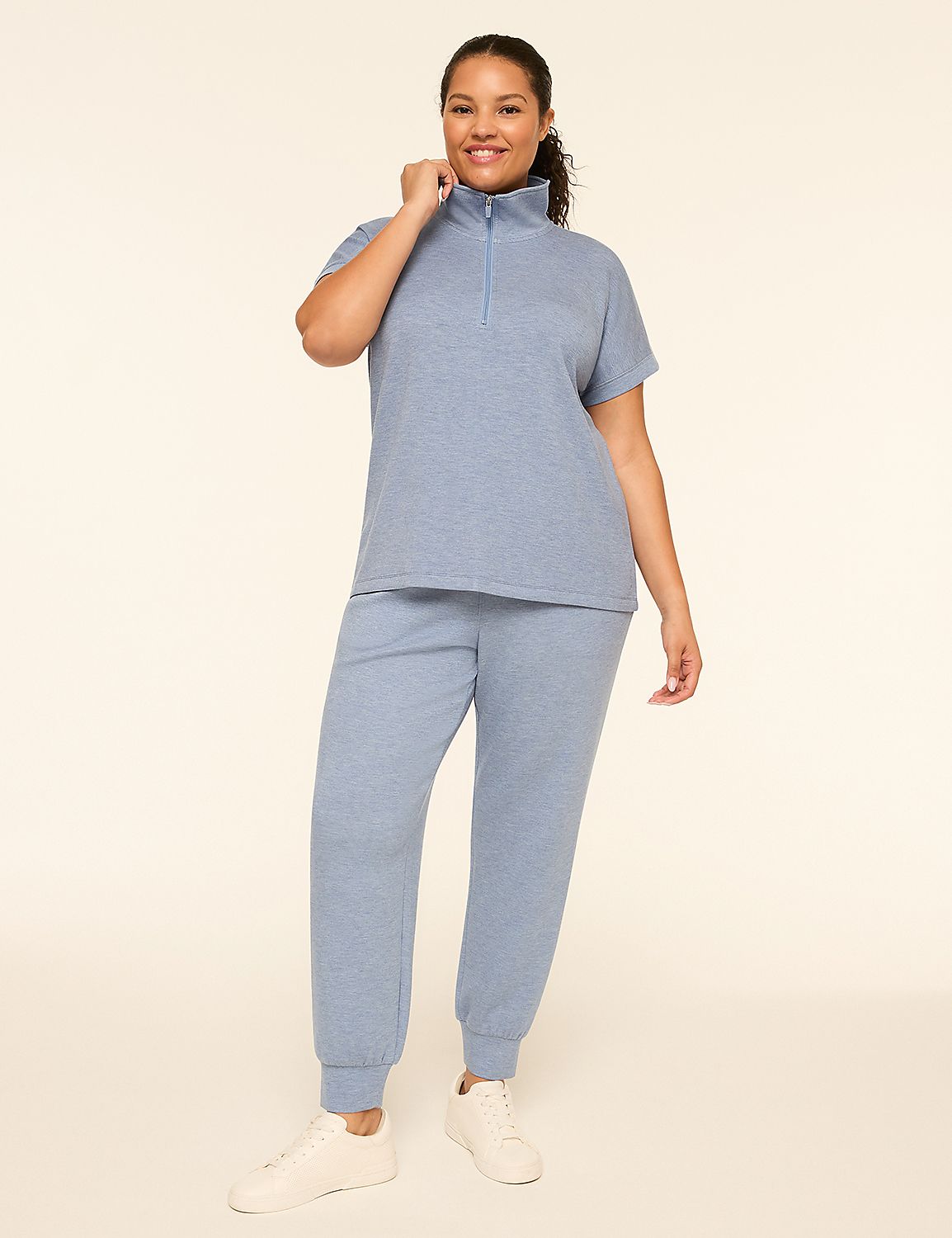 A woman in a blue loungewear set stands against a plain, light-colored background. Product Image 3