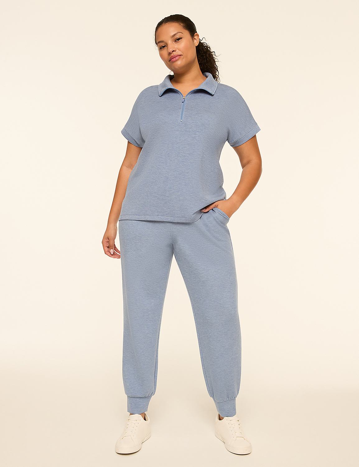 A woman in a blue loungewear set stands against a plain, light-colored background. Product Image 3