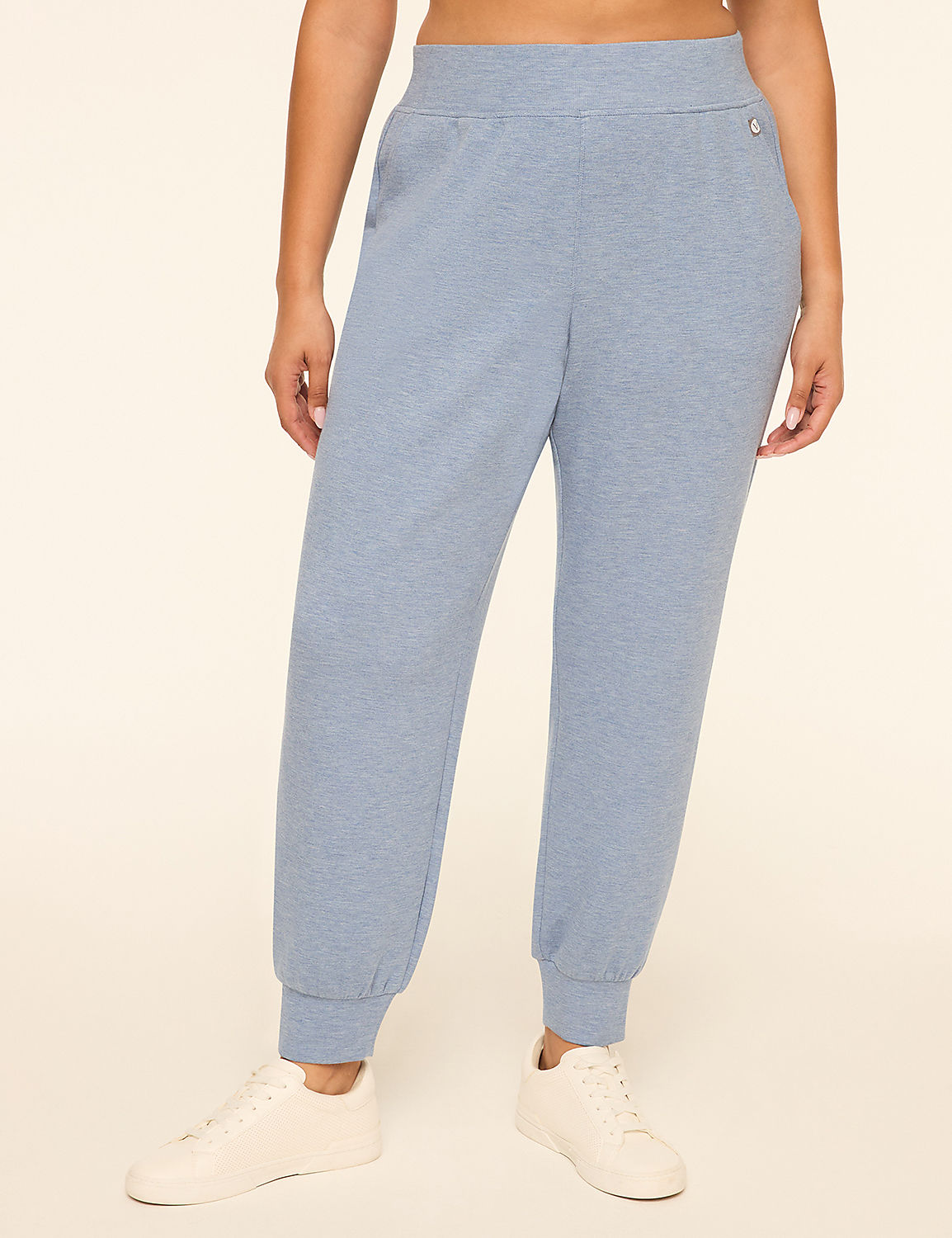 A person wearing light blue sweatpants and white sneakers stands against a plain, light-colored background. Product Image 1