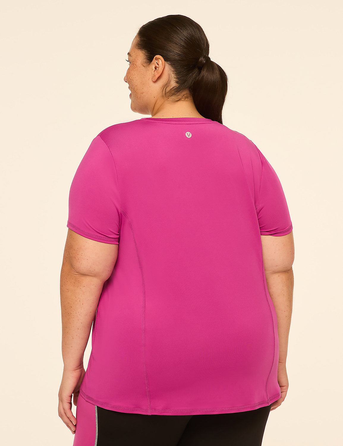 A woman in a bright pink t-shirt stands against a plain, light-colored background. Product Image 2