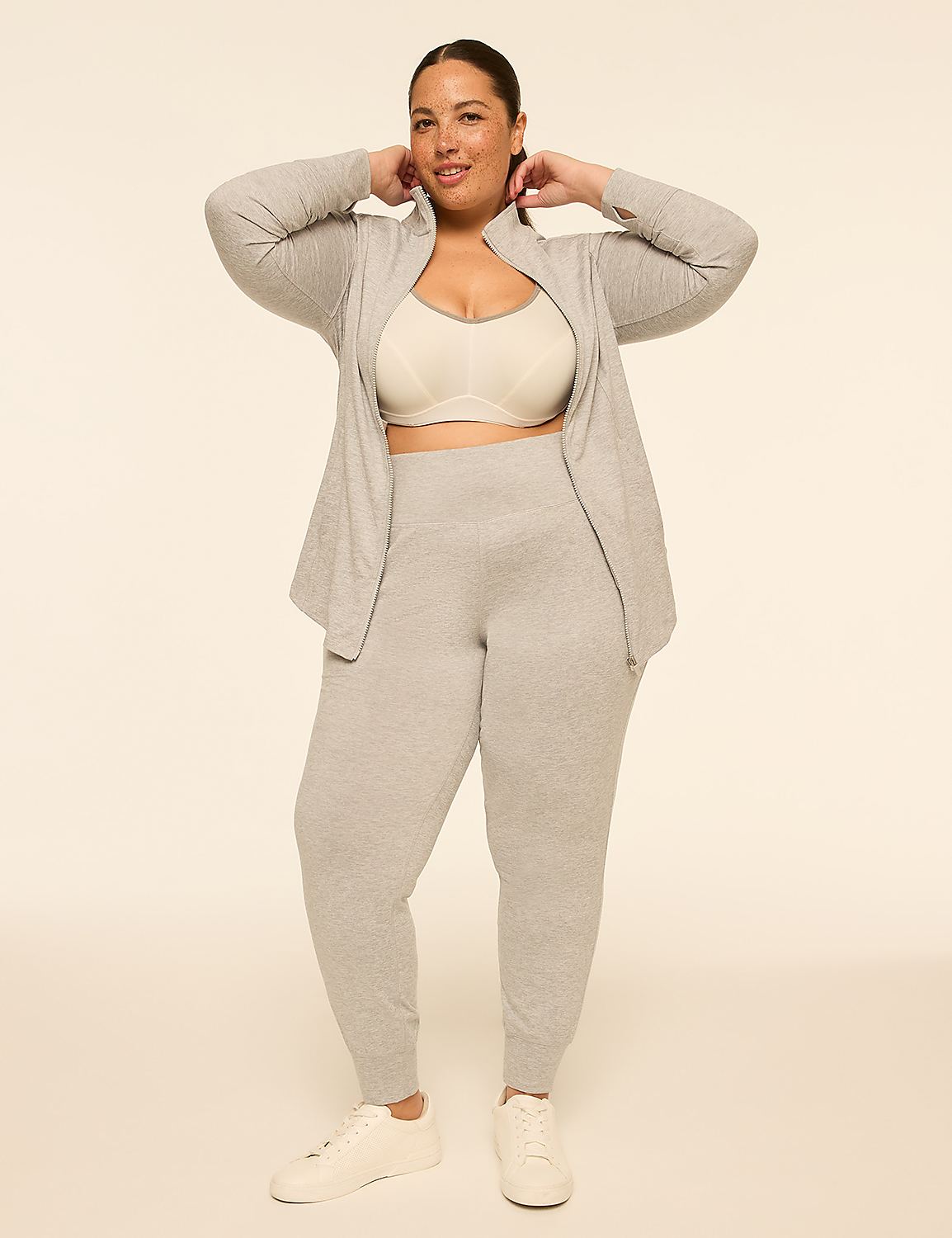A woman in a grey loungewear set and white sneakers stands against a plain, light-colored background. Product Image 3