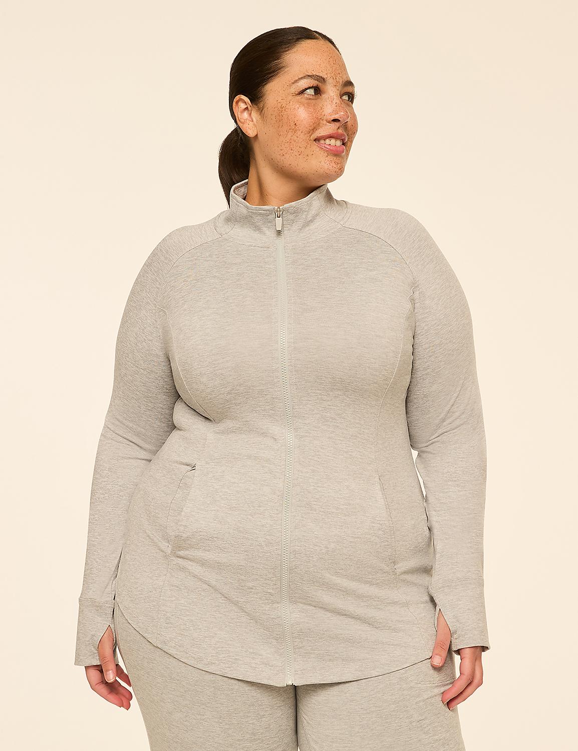 A smiling woman in a grey zip-up jacket stands against a plain, light-colored background. Product Image 1