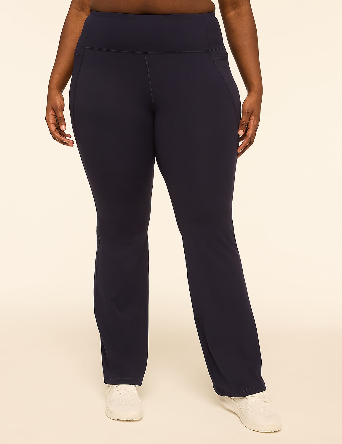 A person in dark blue athletic pants and white sneakers stands against a plain, light-colored background. Product Image 1