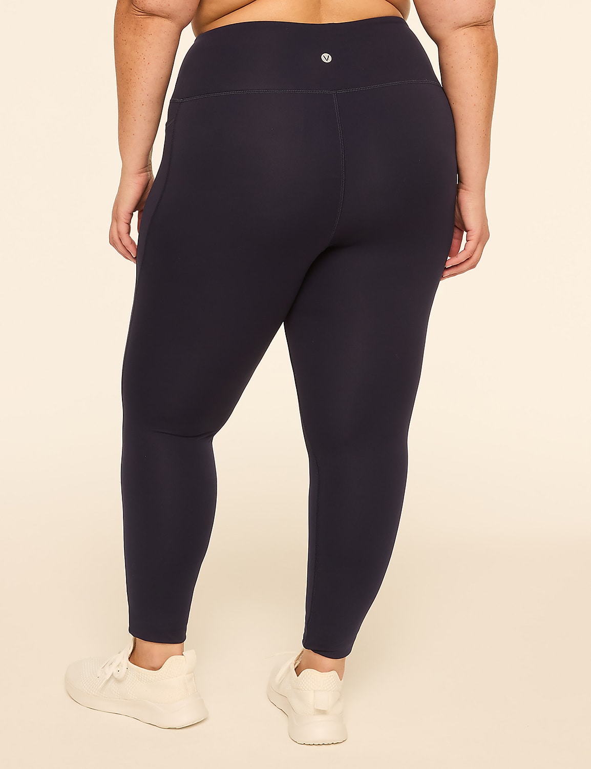 A person wearing dark blue leggings and white sneakers stands against a plain, light-colored background. Product Image 2