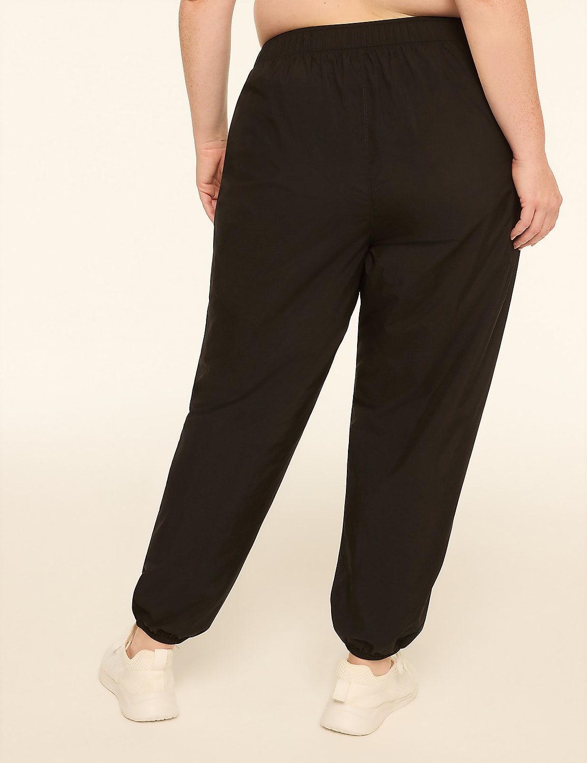 A person wearing black sweatpants and white sneakers stands against a plain, light-colored background. Product Image 2