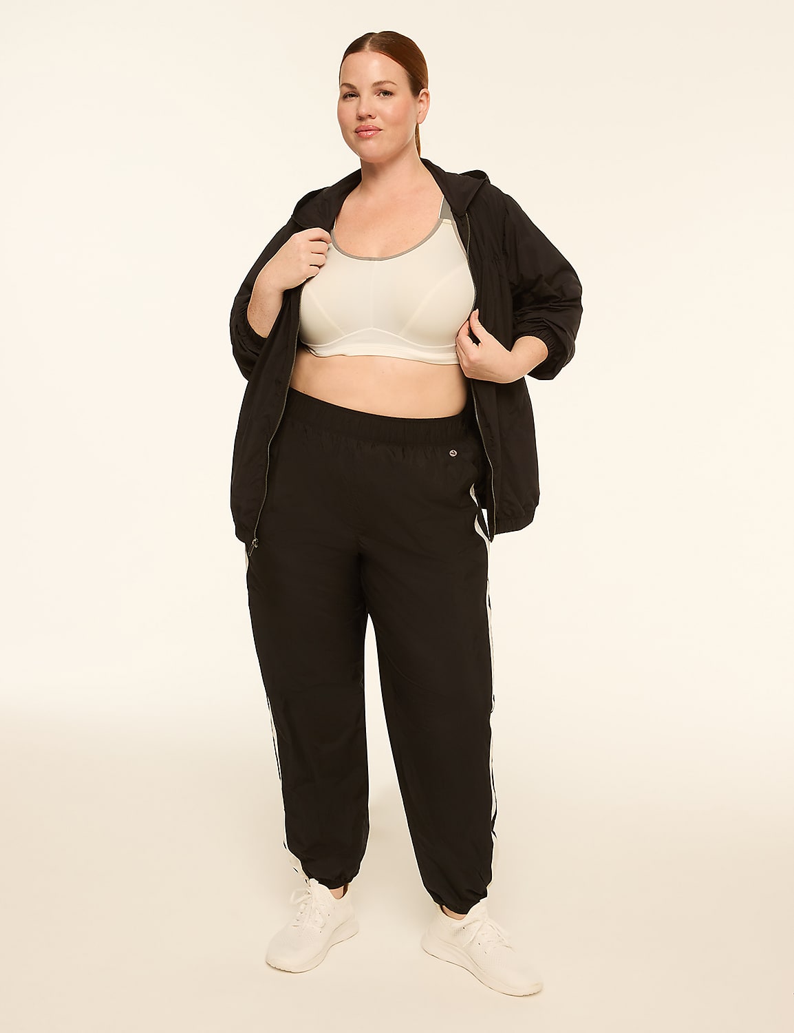 A woman in athletic wear stands against a plain, light-colored background. Product Image 3