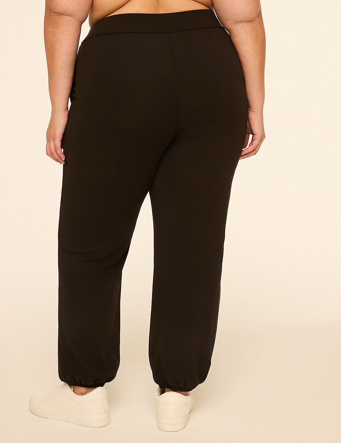 A person wearing black sweatpants and white sneakers stands against a plain, light-colored background. Product Image 2