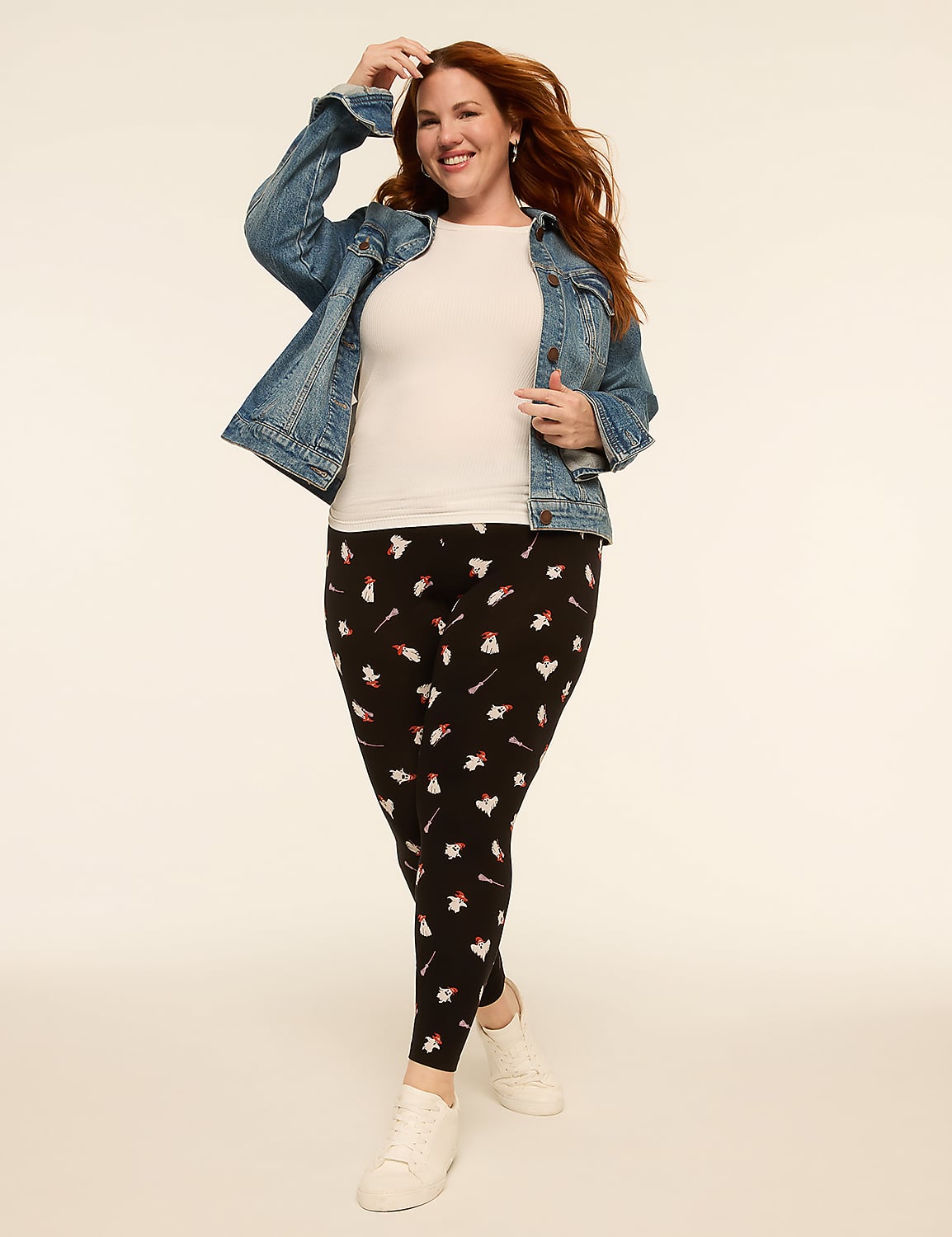 A smiling woman with red hair in a denim jacket and patterned leggings stands against a plain, light-colored background. Product Image 3