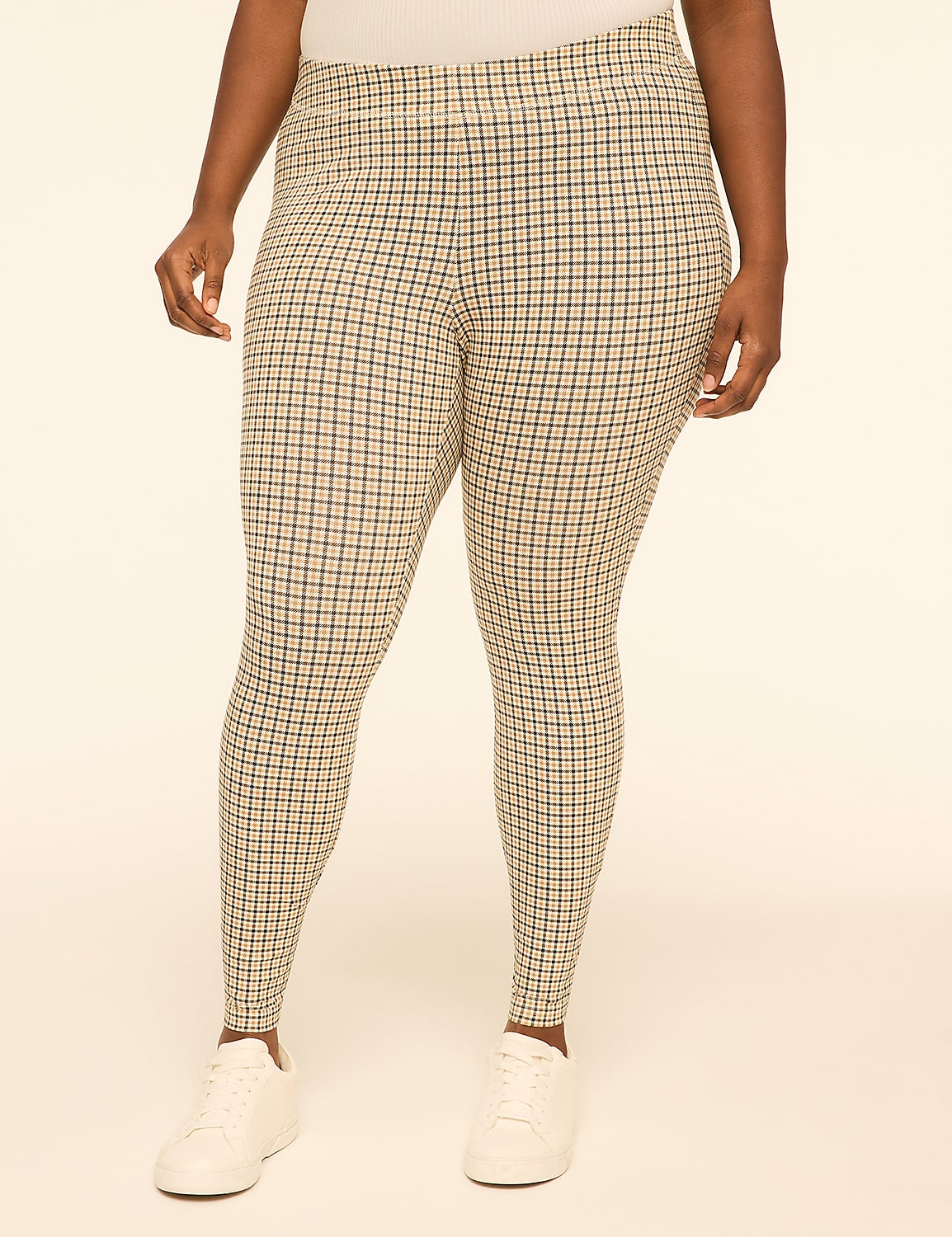 A person wearing plaid leggings and white sneakers stands against a plain, light-colored background. Product Image 1