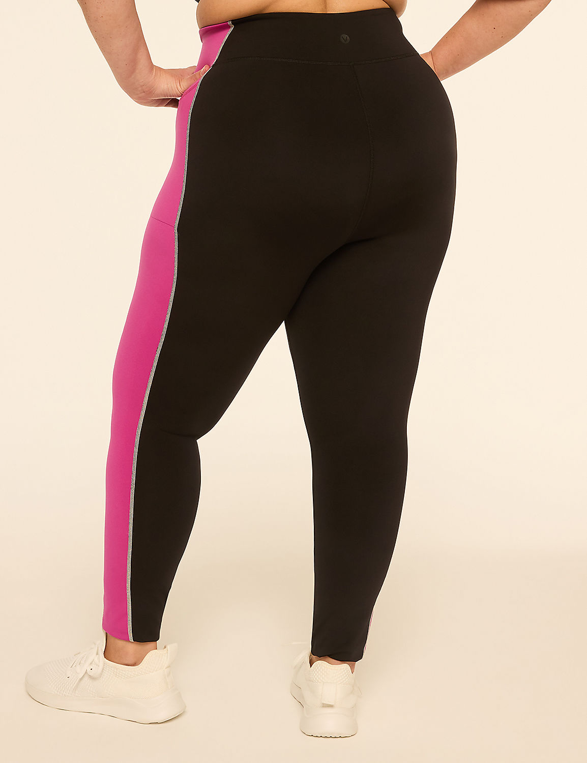 A person wearing black leggings with a pink stripe down the side stands against a plain, light-colored background. Product Image 2