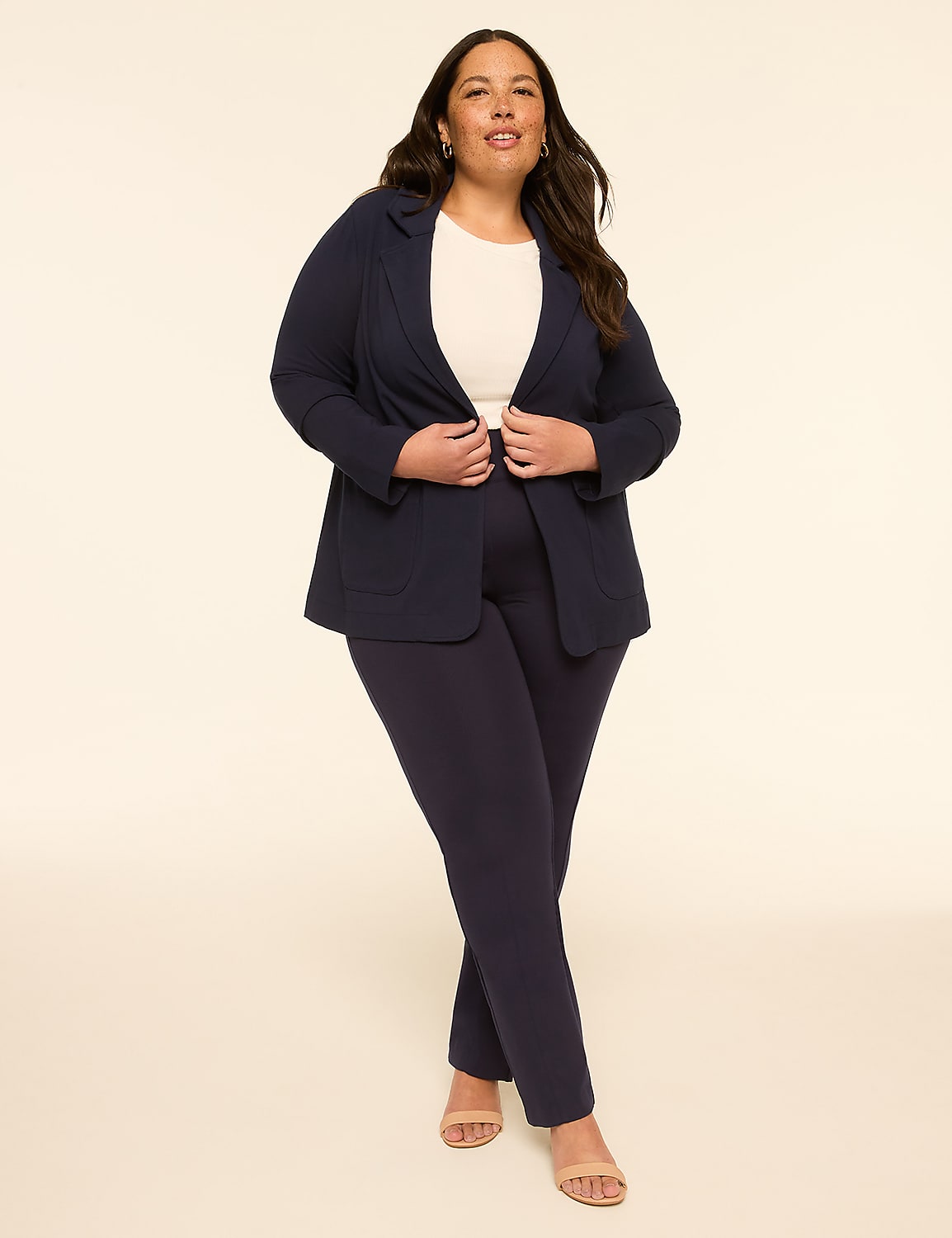 A woman in a navy blue pantsuit stands against a plain, light-colored background. Product Image 3