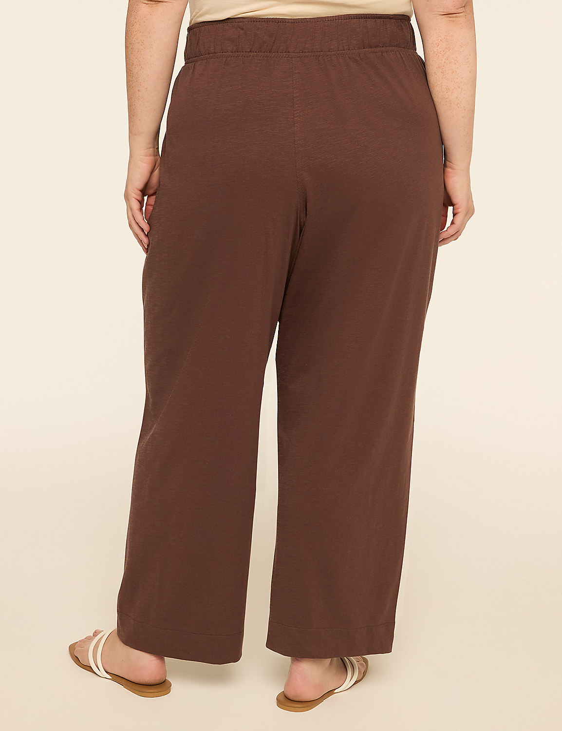 A person wearing brown wide-leg pants and white-strapped sandals stands against a plain, light-colored background. Product Image 2