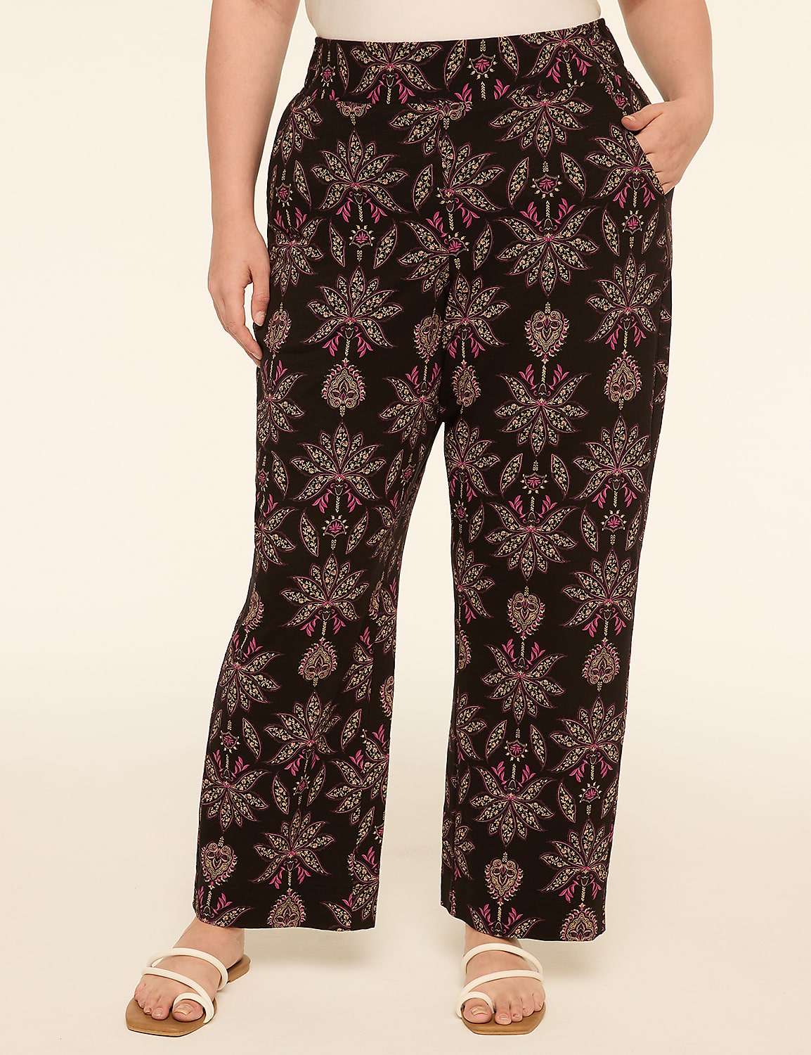 A person wearing patterned pants stands against a plain, light-colored background. Product Image 1