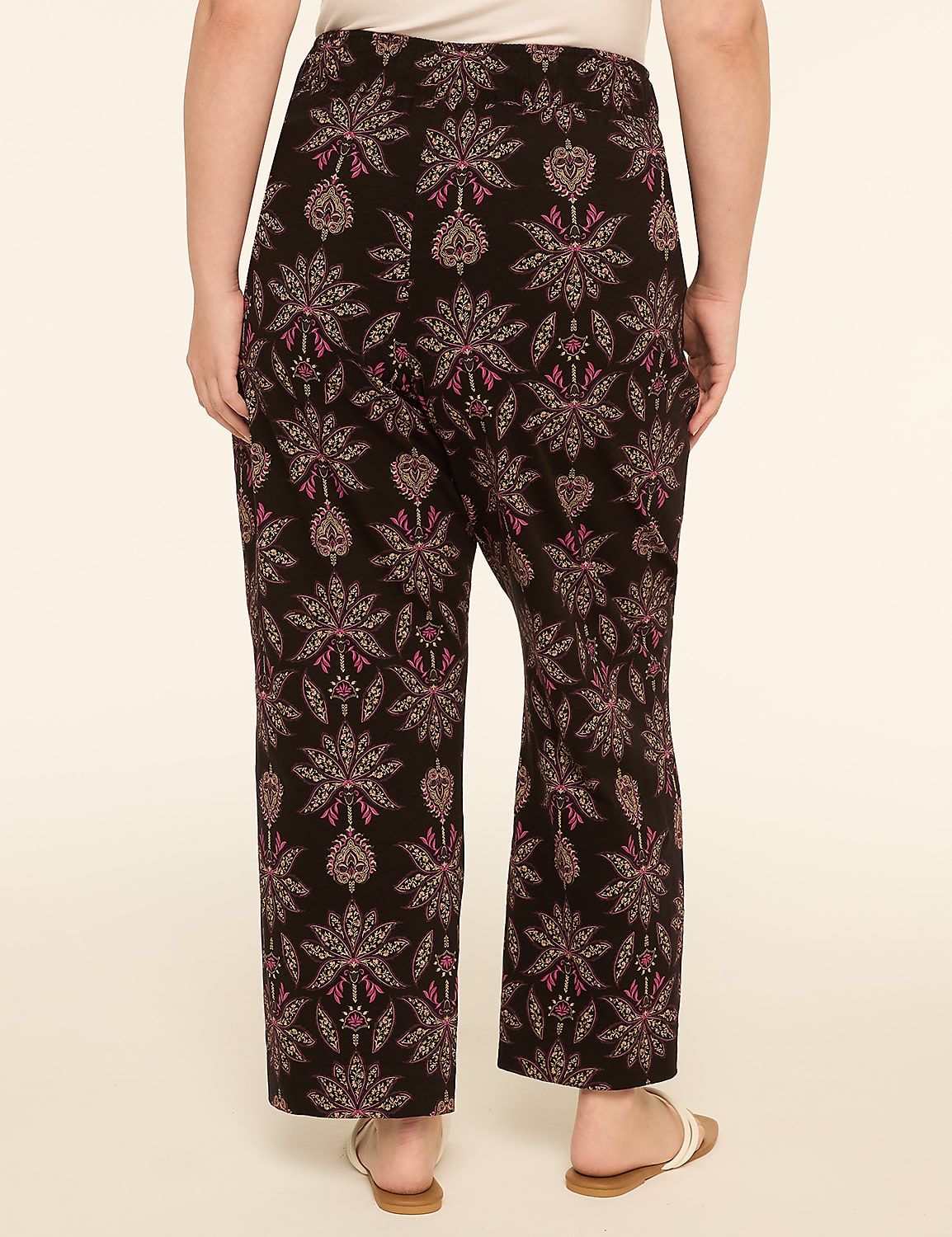 A person wearing patterned pants stands against a plain, light-colored background. Product Image 2