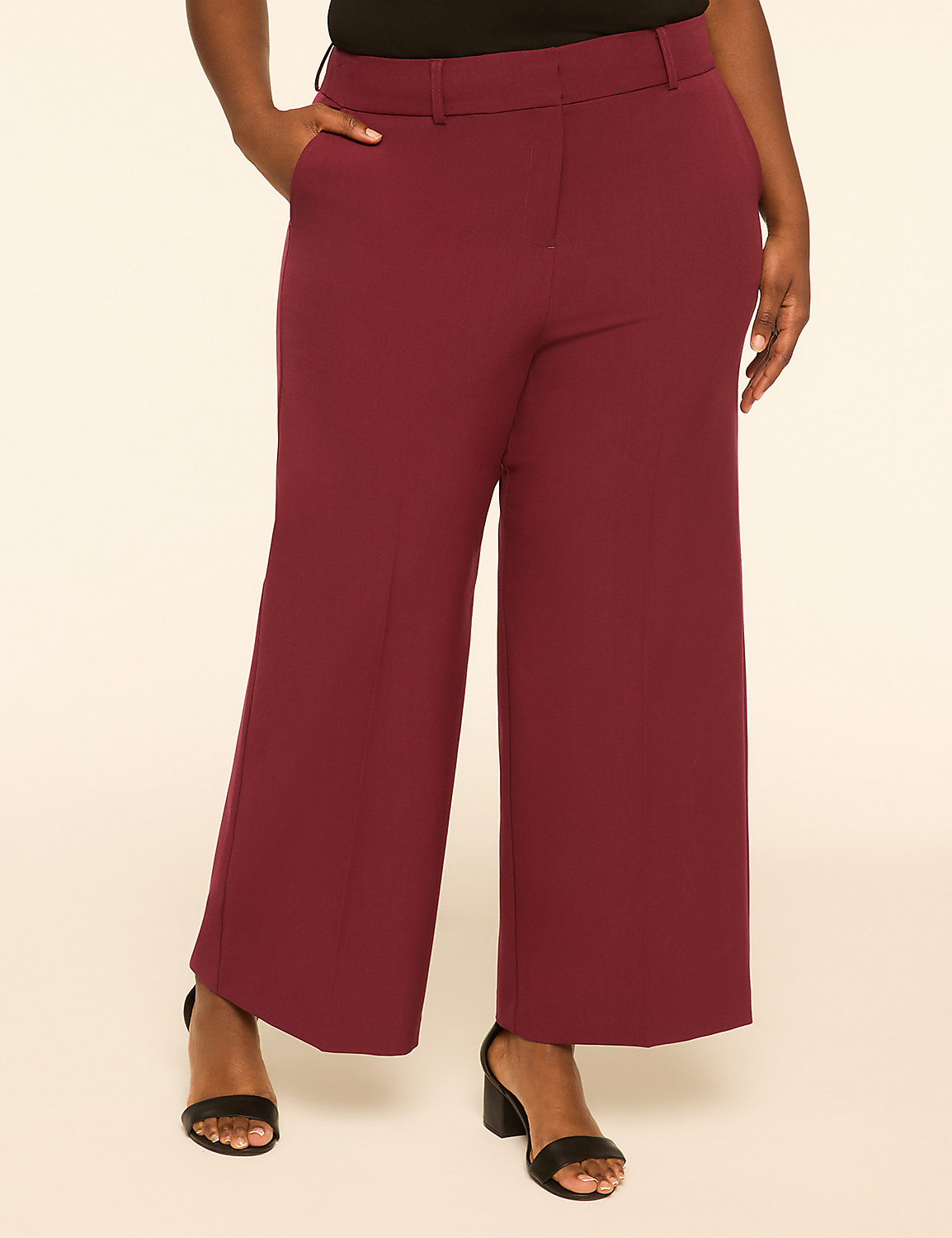 A person stands in burgundy wide-leg pants and black heels against a plain, light background. Product Image 1