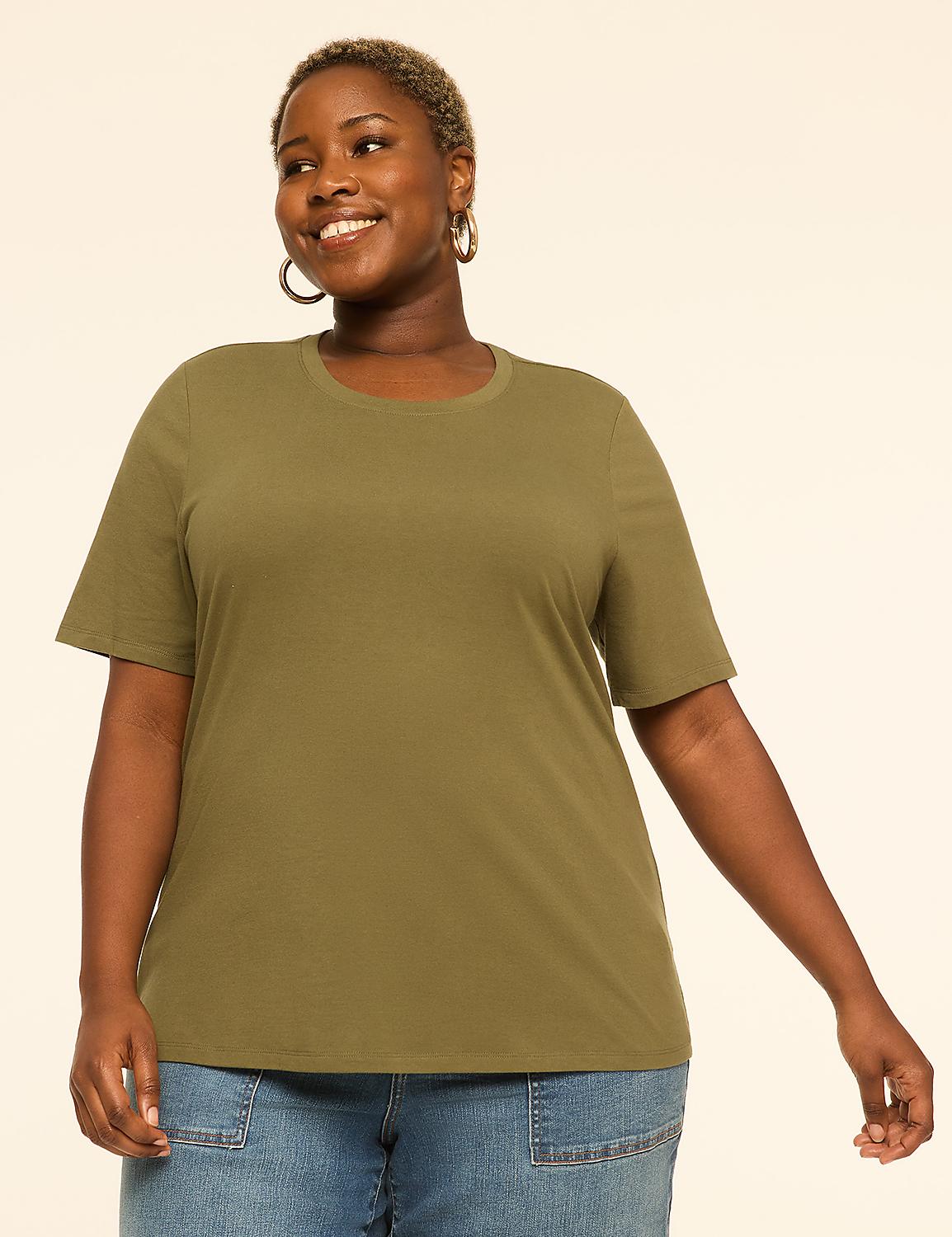 A smiling woman in a green t-shirt and blue jeans stands against a plain, light-colored background. Product Image 1